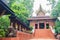 Beautiful Phra Uposatha or Ubosoth in Chiang Saen style with nicely carved wooden structure with unique carved doors at Wat Phra