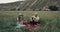 Beautiful picnic time with a young family , man playing at the guitar