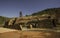 Beautiful picture of a metallic scaffolding towel on a mineral hill surrounded by ruins