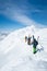 Beautiful picture of skiers climbing the snowy mountain at daytime