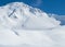 Beautiful picture of snow slope against a mesmerizing mountain  under the sunlight