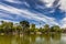 Beautiful picturesque park on the background of blue sky.