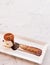 Beautiful piece of Italian Tiramisu on white plate, pistachio cr