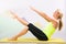 Beautiful pilates instructor with yellow yoga mat