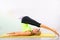 Beautiful pilates instructor with yellow yoga mat