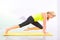 Beautiful pilates instructor with yellow yoga mat