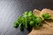 beautiful pile fresh green melissa officinalis tied twine on slate and jute background, close up