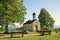 Beautiful pilgrimage chapel at the hill, trees and mountain view, upper bavaria in may