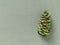 Beautiful pinecone painted green, decorated with gold sequins. In the background is a light green fabric. Copy space. Christmas