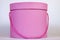 A beautiful pink circular gift box for packing a surprise inside with a closed lid and a cord instead of a ribbon close-up on a