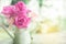 Beautiful pink garden roses flower in vintage jug over nature blur background