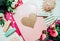 Beautiful and pink notebooks and flowers on a white wooden background with clothespins in spring