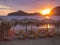 Beautiful pink orange sunset on Agios Georgios Pagon beach at Corfu island, Greece with sun umbrellas empty sunbeds and view on po