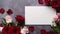 Beautiful pink and red rose flower bouquet and mockup blank note paper on gray background, congratulations and anniversary concept