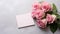Beautiful pink rose flower bouquet and mockup blank note paper on gray background, congratulations and anniversary concept,