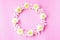 Beautiful pink and white flowers round flat lay in circle on pink pastel background