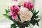 Beautiful pink and white peonies bouquet at rustic old wooden window. Floral decor and arrangement. Gathering flowers. Rural still