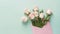 Beautiful pink and white rose flower bouquet in pink envelope on pastel green background, congratulations and anniversary concept