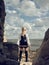 Beautiful pirate woman standing on the beach in boots.