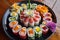 a beautiful plate of sushi, with delicate and colorful rolls