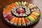 a beautiful plate of sushi, with delicate and colorful rolls