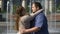 Beautiful plump woman tenderly hugging her obese boyfriend, outdoor date slow-mo