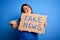 Beautiful plus size woman holding fake news banner for false journalism over isolated background very happy pointing with hand and