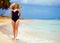 Beautiful plus size woman walking on summer beach