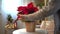 Beautiful poinsettia in wicker pot, gifts and space for text on blurred holiday decoration background. Traditional