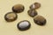 Beautiful polished brown smoky quartz stones on a yellow background