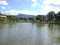 Beautiful pond landscape, trees on the sides and shadows of clouds