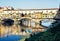 Beautiful Ponte Vecchio is mirroring in the river Arno, Florence