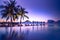 Beautiful poolside and sunset sky. Luxurious tropical beach landscape, deck chairs and loungers and water reflection