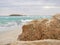 Beautiful porous rocks on Nissi beach with rolling sea with waves on a cloudy day in Ayia Napa, Cyprus