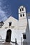 Beautiful portal and clock tower of San Antonio church with art iron bars in Frigiliana - Spanish white village Andalusia