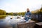 Beautiful portrait of a 90s redhead scandinavian teenager girl in jeans in a park near a lake