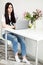 Beautiful portrait european woman working laptop in white room, freelance girl, business and lifestyle concept