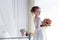 Beautiful portrait of a gentle cute happy bride in a white dress with a bright little colored bouquet