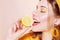 A beautiful portrait of a girl who eats a lemon, bites off a slice of lemon, a girl sniffs a lemon. Health, skin beauty, lemon-