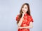 Beautiful portrait happy Chinese New Year young asian woman wear cheongsam fashion think idea 