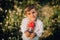 Beautiful portrait of little ukrainian boy in dandelions garden. Child in traditional embroidery vyshyvanka shirt