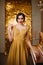 Beautiful portrait retro woman long luxury elegant gold dress fashion style 1920