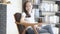 Beautiful portrait young asian woman sitting on chair with smile and happy at living room, moving panning camera