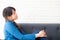 Beautiful portrait young asian woman sitting and smiling happy and looking something on sofa showing future or planning