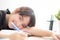 Beautiful portrait young asian woman smile and happy writing learning exam or homework and lying with desk