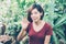 Beautiful portrait young asian woman smiling waving hand in garden at home, Friendly girl and expression positive of emotion.