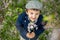 Beautiful portrait of a young preschool child holding flower