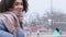 Beautiful positive ethnic girl model student teen with curly hair Afro American nationality wears warm outerwear and