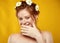 Beautiful positive redheaded girl with a chamomile crown on her head