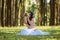 beautiful potrait asian woman siting and listening to headphone music in a pine forest and holding retro camera with rose flowers